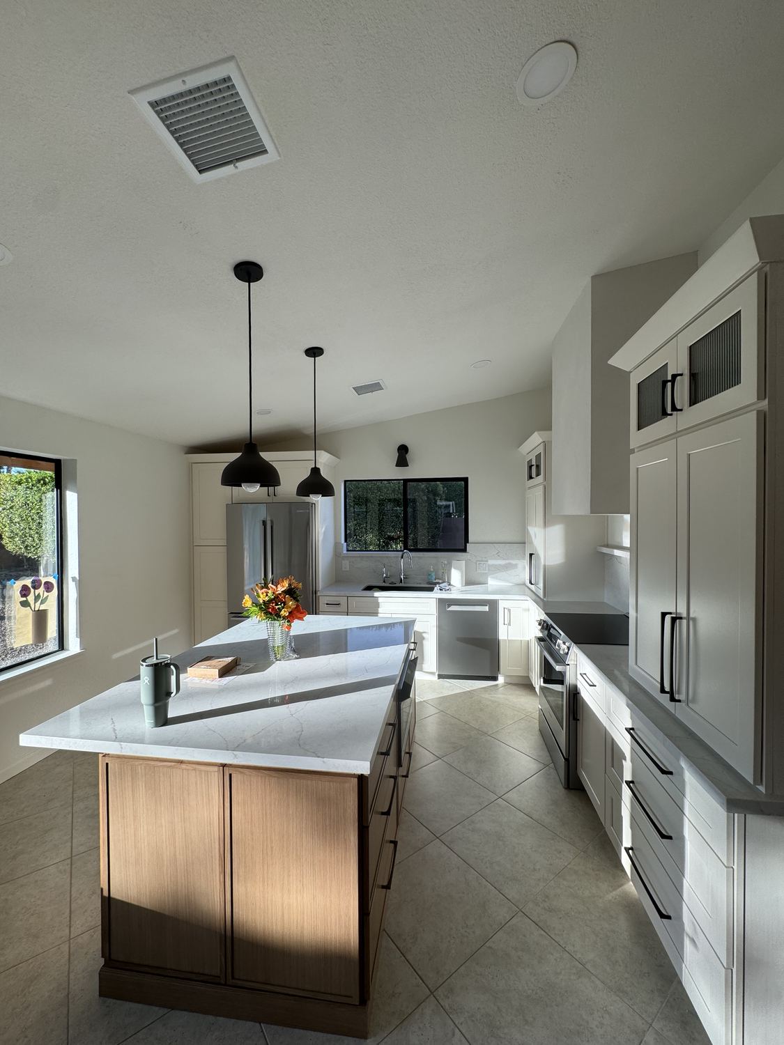 Custom kitchen island and painted cabinetry by Sunrise Door n Trim